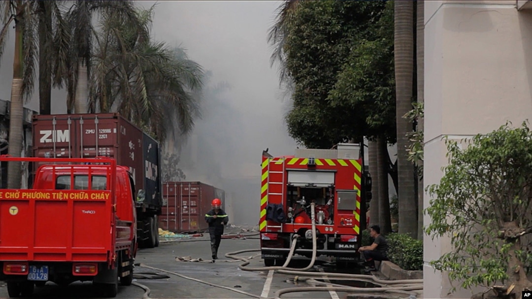 A firefighter runs as Taiwanese bicycle factory Tan Than Industries burns in Di An Town, Binh Duong province, May 14, 2014.