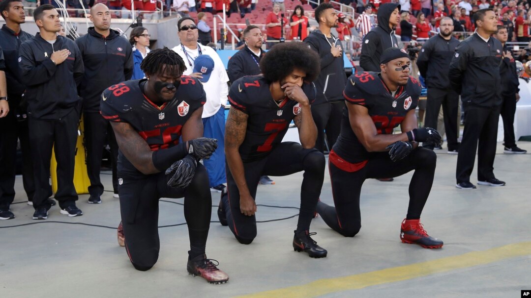 San Francisco 49ers outside linebacker Eli Harold (58), quarterback Colin Kaepernick (7) and safety Eric Reid (35) kneel during the national anthem before an NFL football game Oct. 6, 2016.