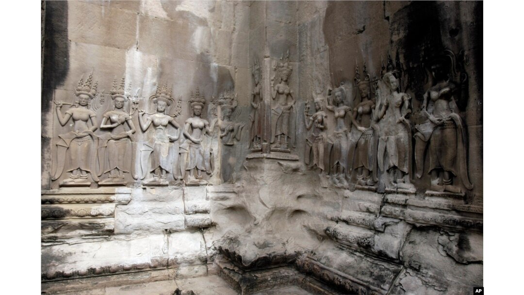 In this July 19, 2012 photo, Apsara sculptures are carved on a wall of the Angkor Wat temple complex in Siem Reap, northwest of Phnom Penh, Cambodia.