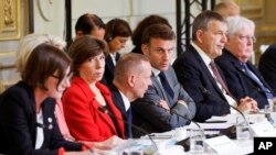 French President Emmanuel Macron, center, attends a meeting with officials from Western and Arab nations, the United Nations and nongovernmental organizations at the Elysee Palace, in Paris, Nov. 9, 2023. 