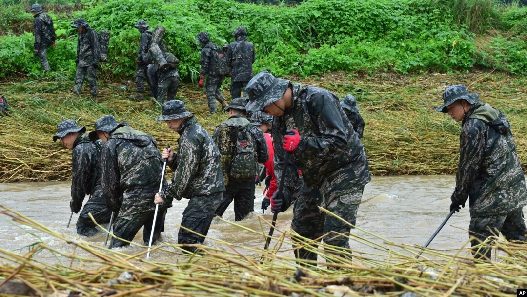 South Korean marines search for missing people in floodwaters in Yecheon, South Korea, July 18, 2023. 