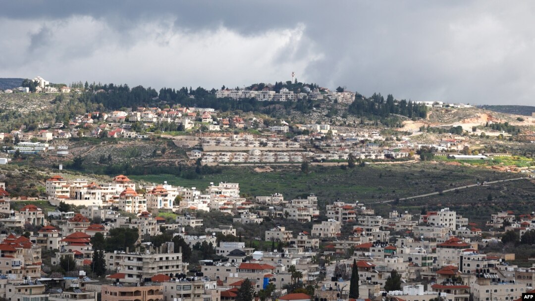A picture taken in the village of Turmus Ayya near Ramallah city shows the nearby Israeli Shilo settlement in the background, in the occupied West Bank on Feb. 18, 2024. 