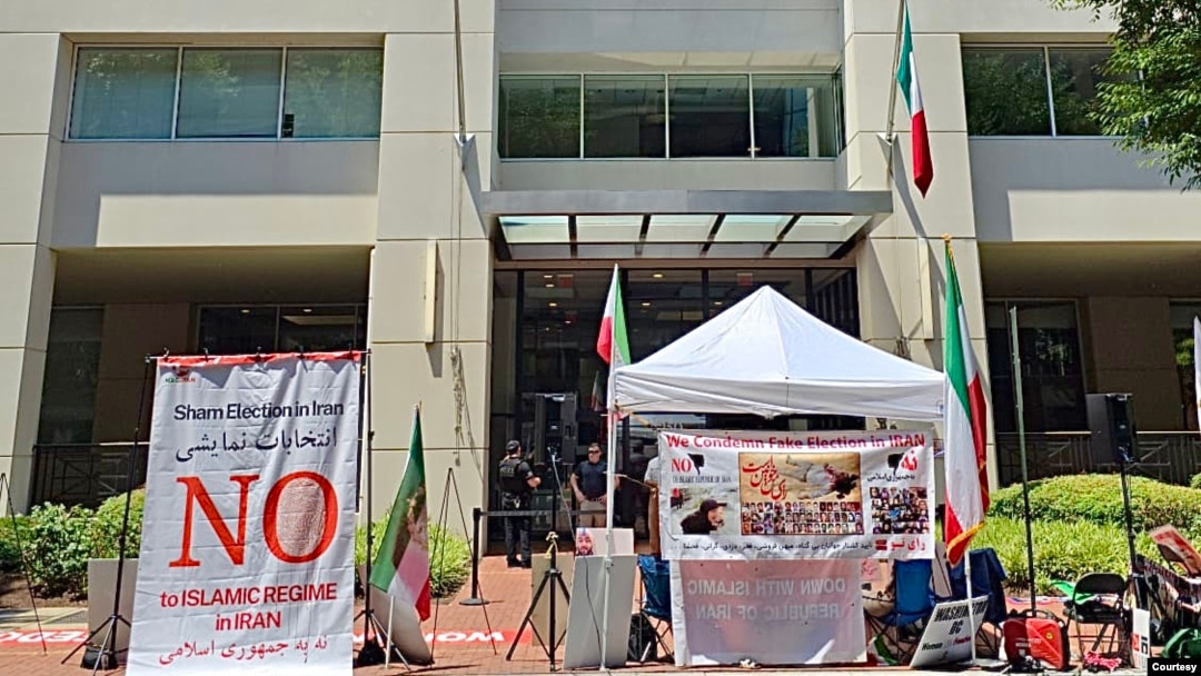 Iranian American activists from the National Solidarity Group for Iran protest outside Iran's interests section office in Washington on July 5, 2024, denouncing its use as a ballot station for the runoff vote of Iran's presidential election. (Courtesy of NSGIran)