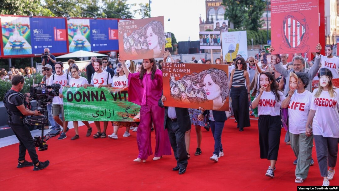 Supporters of Iran's women march at the Venice Film Festival in Venice, Italy, Sept. 2, 2023. This year's festival also saw the world premiere of 'Tatami,' a thriller co-directed by Iranian and Israeli filmmakers and shot in secret to prevent possible interference by Tehran.