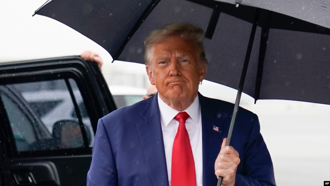 FILE - Former President Donald Trump walks over to speak with reporters before he boards his plane at Ronald Reagan Washington National Airport, Aug. 3, 2023, in Arlington, Va., after facing a judge on federal conspiracy charges.