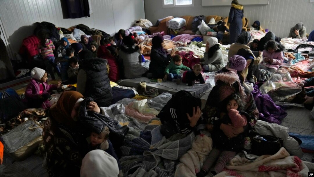 FILE - Syrians gather at a shelter in Antakya, southeastern Turkey, Feb. 10, 2023. For Syrians fleeing the violence back home, the earthquake that struck in Turkey and Syria is but the latest tragedy.