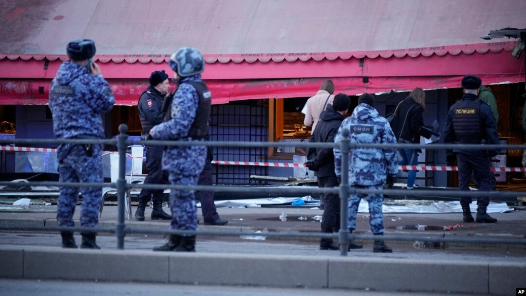 Police officers stand at the site of an explosion at a cafe in St. Petersburg, Russia, April 2, 2023.