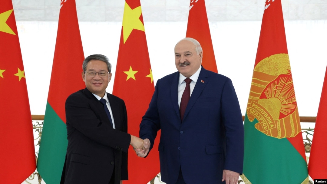 Belarusian President Alexander Lukashenko shakes hands with China's Premier Li Qiang during a meeting in Minsk, Belarus, Aug. 22, 2024, in this photo from the Press Service of the President of the Republic of Belarus.