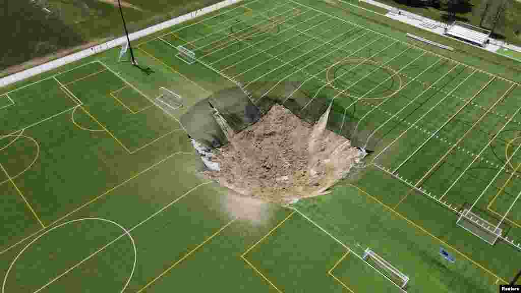 A drone view shows a sinkhole that formed on a turf soccer field at Gordon Moore Park in Alton, Illinois, June 27, 2024.