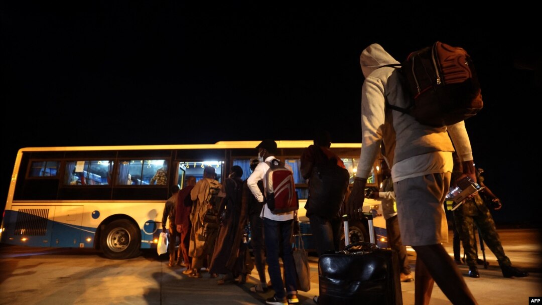 Fleeing Nigerian students prepare to enter a shuttle after being evacuated from Sudan to Nigeria at the Nnamdi Azikwe International Airport in Abuja, Nigeria, May 4, 2023.