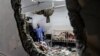 People inspect the damage in a room following Israeli bombardment at Nasser hospital in Khan Yunis in the southern Gaza Strip on Dec. 17, 2023.