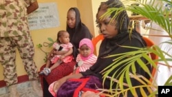 Recently freed Chibok schoolgirls, now 26 years old, with their children are photographed at the Army Maimalari Cantonment in Maiduguri, Nigeria, May 4, 2023. 
