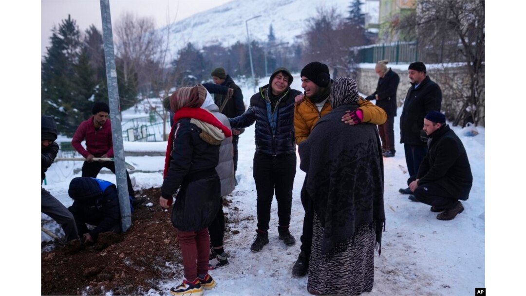 FILE - Relatives and friends of Syrian refugee Naziha Al-Ahmad bury her in a cemetery after she died during an earthquake, in Elbistan, southeastern, Turkey, Feb. 10, 2023.
