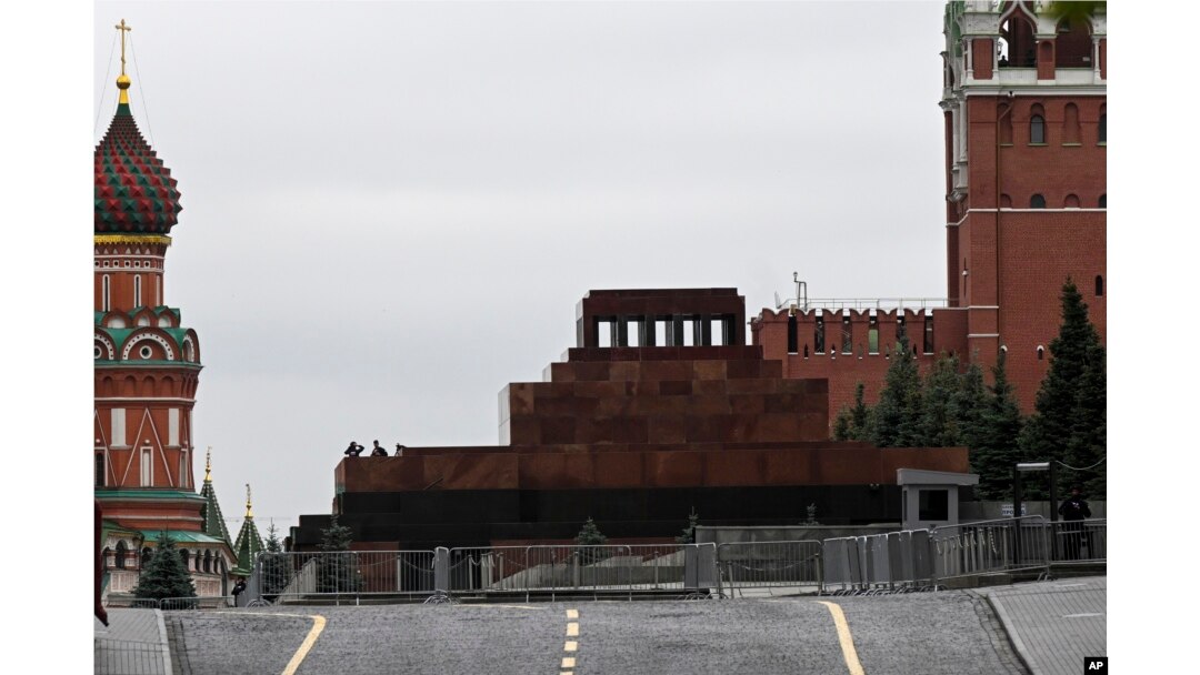 Two servicemen stand on a side roof of the Lenin mausoleum closed for security reasons, in Moscow's Red Square, June 24, 2023