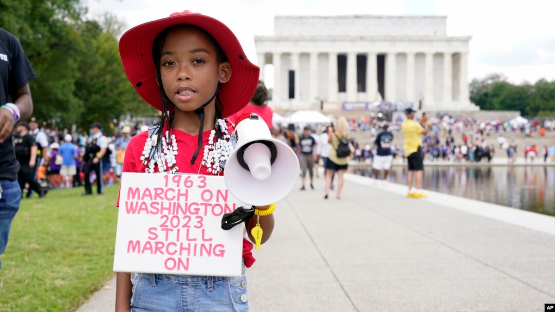 T'Kyrra Terrell, 6, poses for a portrait on her way to the 60th Anniversary of the March on Washington at the Lincoln Memorial in Washington, Aug. 26, 2023.