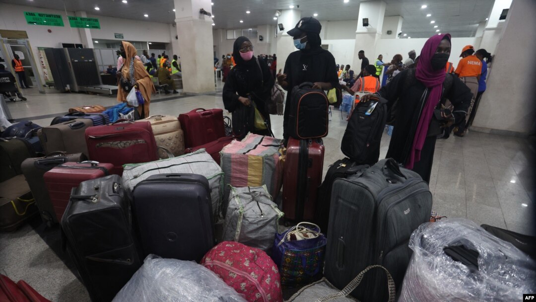 Fleeing Nigerian students in Sudan prepare to get their luggage after being evacuated from Sudan to Nigeria at the Nnamdi Azikwe International Airport in Abuja, Nigeria, May 4, 2023.