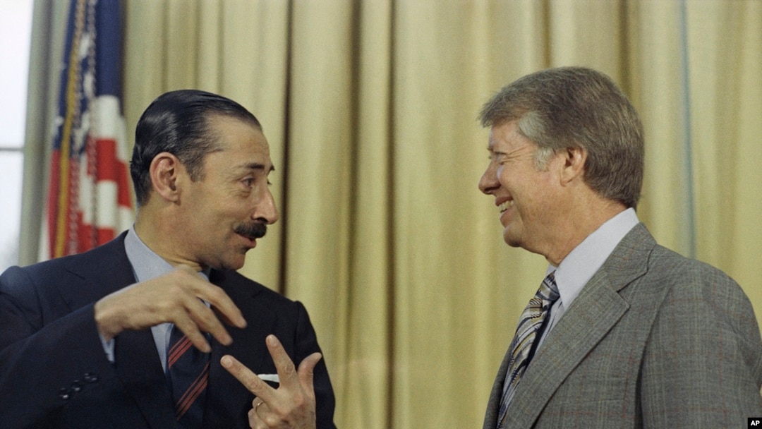 FILE - President Jimmy Carter with Jorge R. Videla, president of Argentina, at the White House, Sept. 9, 1977.