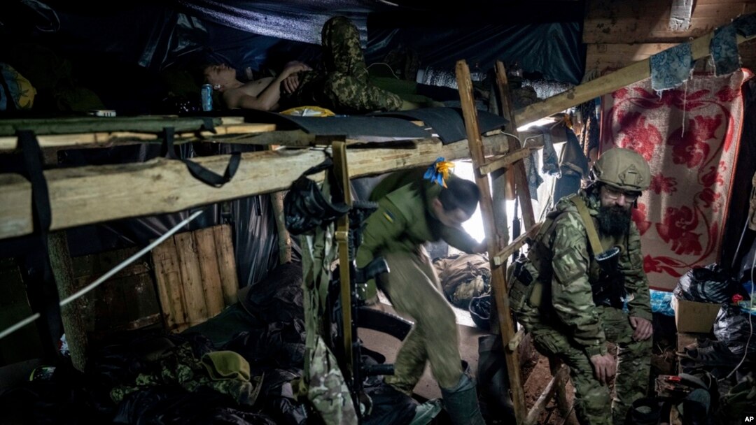 Ukrainian paratroopers of 80 Air Assault brigade rest inside a dugout at the front line near Bakhmut, Ukraine, March 10, 2023.