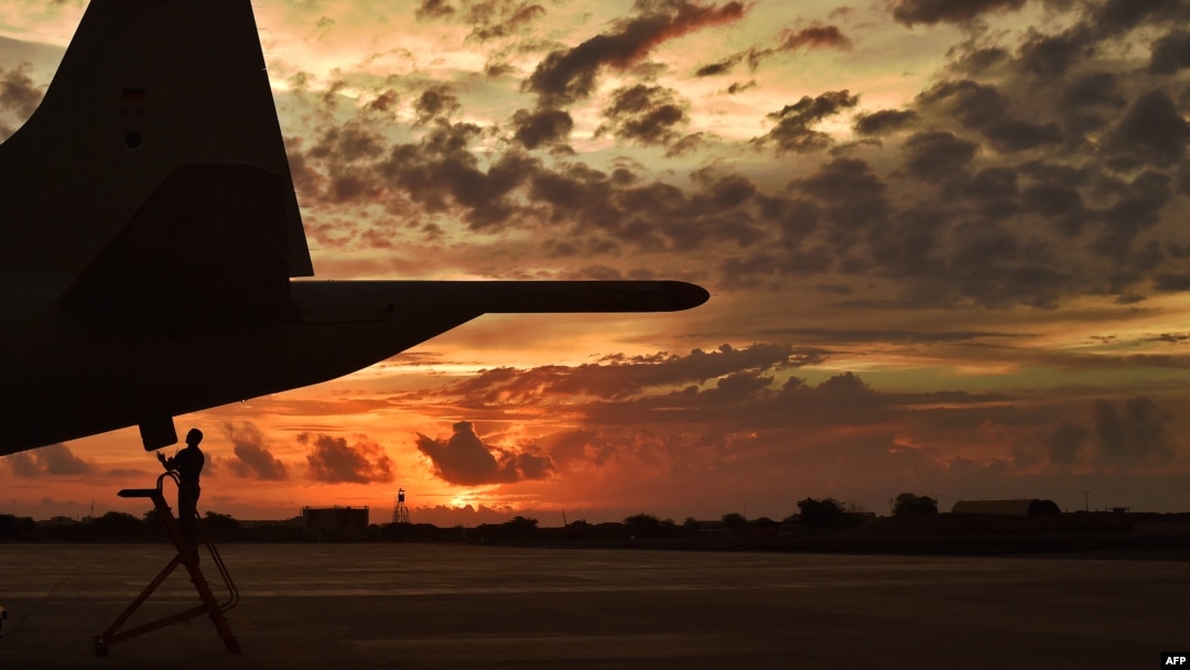 FILE - A German member of the European Naval Force performs technical checks on an anti-piracy reconnaissance plane as part of Operation Atalanta at a French military base in Djibouti, May 5, 2015.