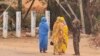 A soldier talks to women on a street in Khartoum on June 6, 2023, as fighting continues in war-torn Sudan. 