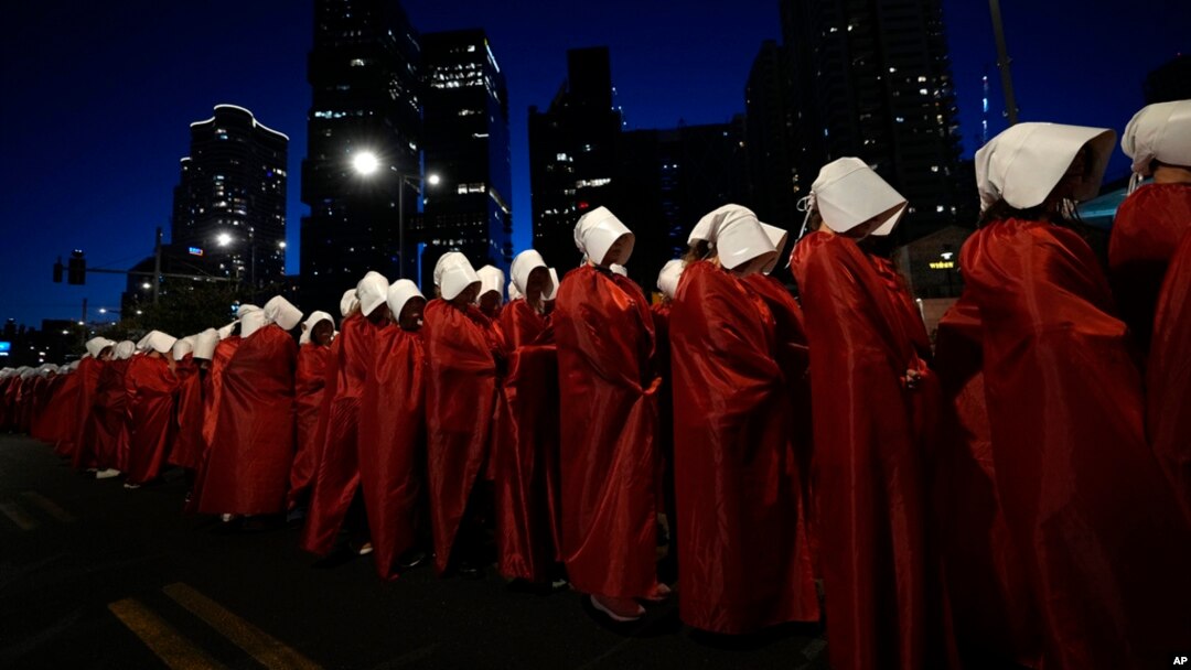 Israeli women's rights activists dressed as characters in the television series 'The Handmaid's Tale' protest plans by Prime Minister Benjamin Netanyahu's government to overhaul the judicial system, in Tel Aviv, Israel, March 11, 2023.