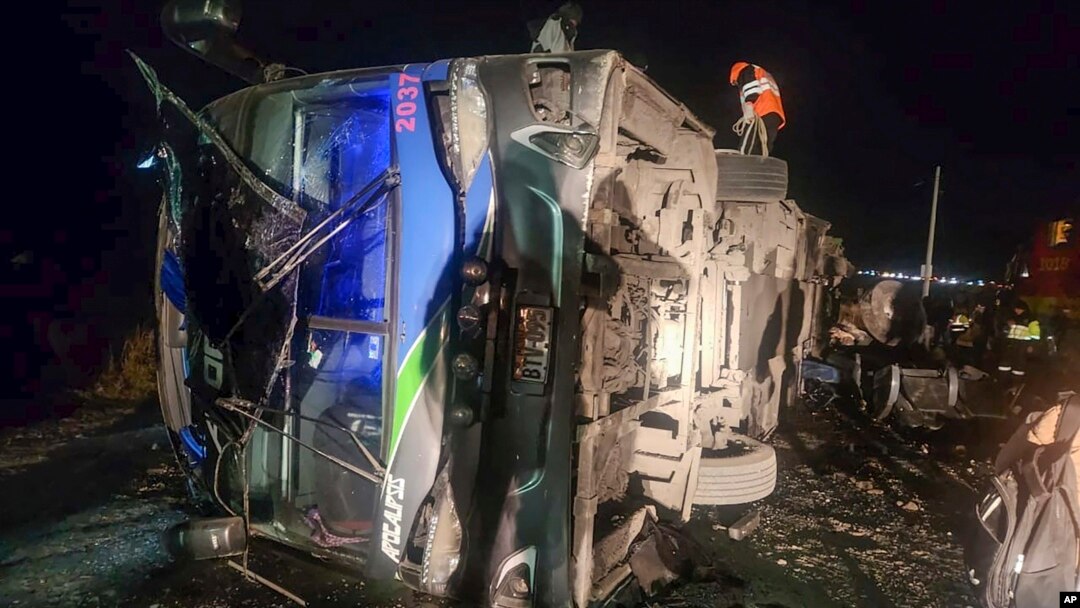In this handout photo provided by Peru's Highway Police, rescue workers attend to a bus that collided with a cargo train in La Oroya, Peru, May 26, 2024.
