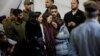Mourners react during the funeral of Israeli military commander Lieutenant Colonel Tomer Grinberg, who was killed in northern Gaza, at Mount Herzl military cemetery in Jerusalem, Dec. 13, 2023. 