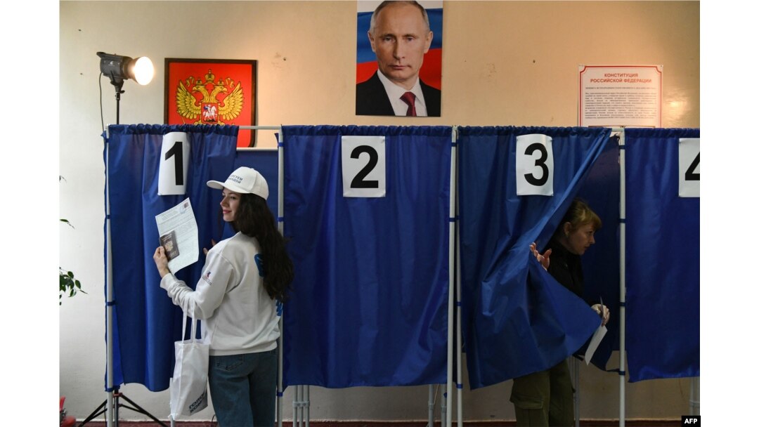 Voters cast ballots in Russia's presidential election at a polling station in Donetsk, Russian-controlled Ukraine, amid the Russia-Ukraine conflict, March 16, 2024.