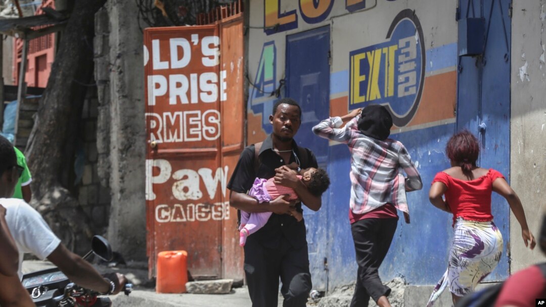FILE - Residents flee their homes to escape clashes between armed gangs in Port-au-Prince, Haiti, on Aug. 15, 2023.
