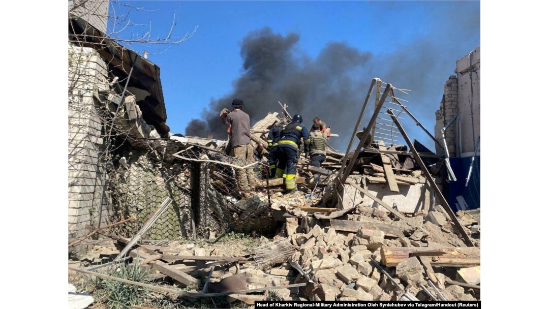 Rescuers and police work the site of a residential building destroyed during Russian airstrikes, in the village of Lyptsi, Kharkiv region, Ukraine, April 10, 2024.