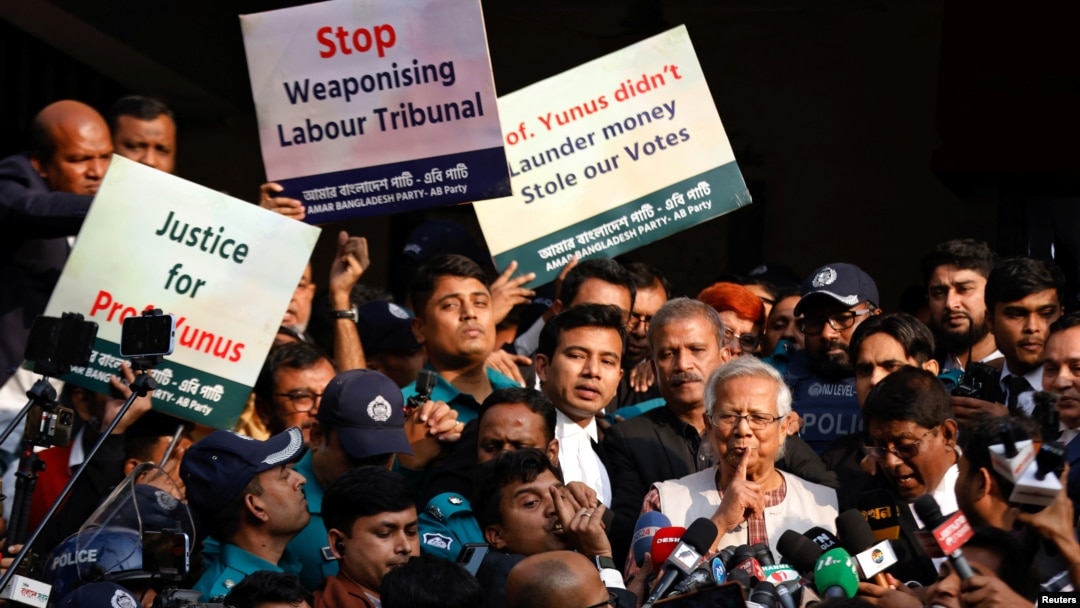 Bangladeshi Nobel peace laureate Muhammad Yunus (in white vest) gestures in front of a court house after being sentenced to six months in prison in a labor law violation case, in Dhaka, Bangladesh, Jan. 1, 2024.