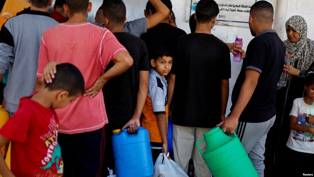 Palestinians gather to collect water, amid shortages of drinking water, as the Israeli-Palestinian conflict continues, in Khan Younis in the southern Gaza Strip, Oct. 15, 2023.
