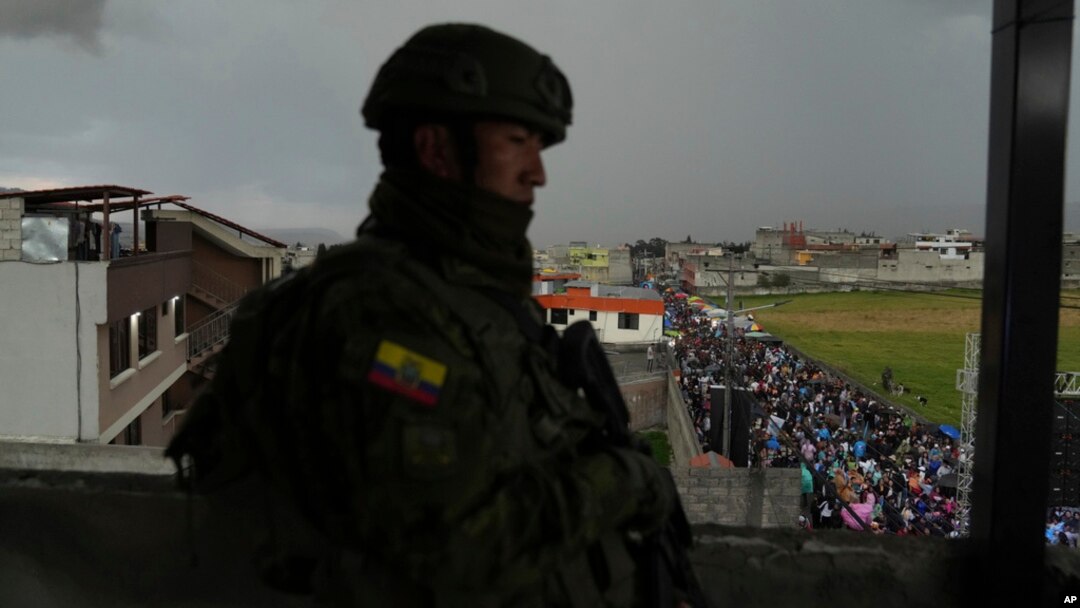 A soldier stands guard as supporters of presidential candidate Luisa Gonzalez, of the Citizen's Revolutionary Movement, attend a campaign rally in Quito, Ecuador, Oct. 11, 2023. 