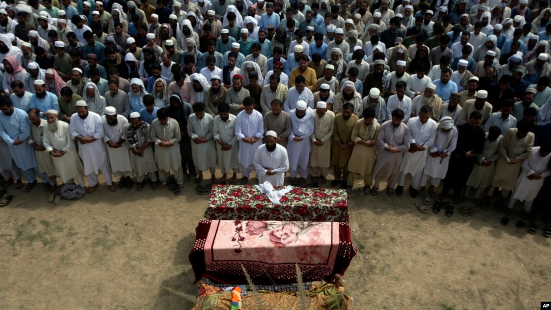FILE - Relatives and mourners attend the funeral of victims who were killed in a suicide bomber attack in the Bajaur district of Khyber Pakhtunkhwa, Pakistan, July 31, 2023.