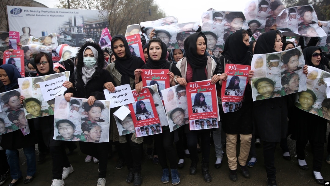 Women march in the Afghan capital of Kabul on Wednesday, Nov. 11, 2015 with pictures showing ethnic Hazaras who were allegedly killed by the Taliban, calling for a new government that can ensure security in the country. 