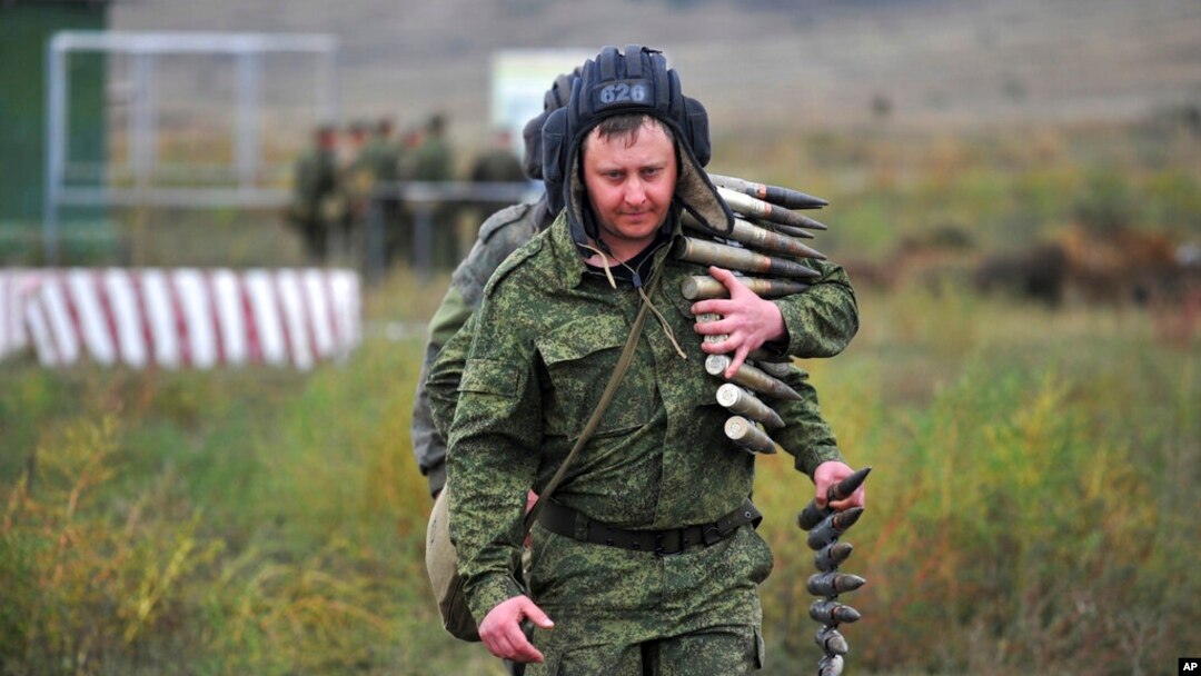 FILE - Recruits carry ammunition during military training at a firing range in the Rostov-on-Don region in southern Russia, Oct. 4, 2022. Russian Defense Minister Sergei Shoigu said Oct. 28 that Russia had completed the mobilization of 300,000 reservists drafted to fight in Ukraine.