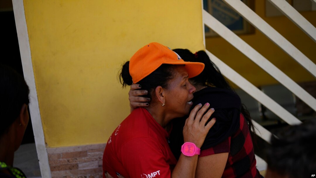 Magaly Colmenares cries as the body of her seven-year-old grandson Angel Senprum is brought to a community health center in Las Tejerias, Venezuela, Oct. 10, 2022.