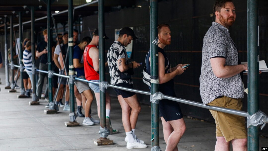 People wait in line to receive the monkeypox vaccine before the opening of a new mass vaccination site at the Bushwick Education Campus in Brooklyn, New York, July 17, 2022.