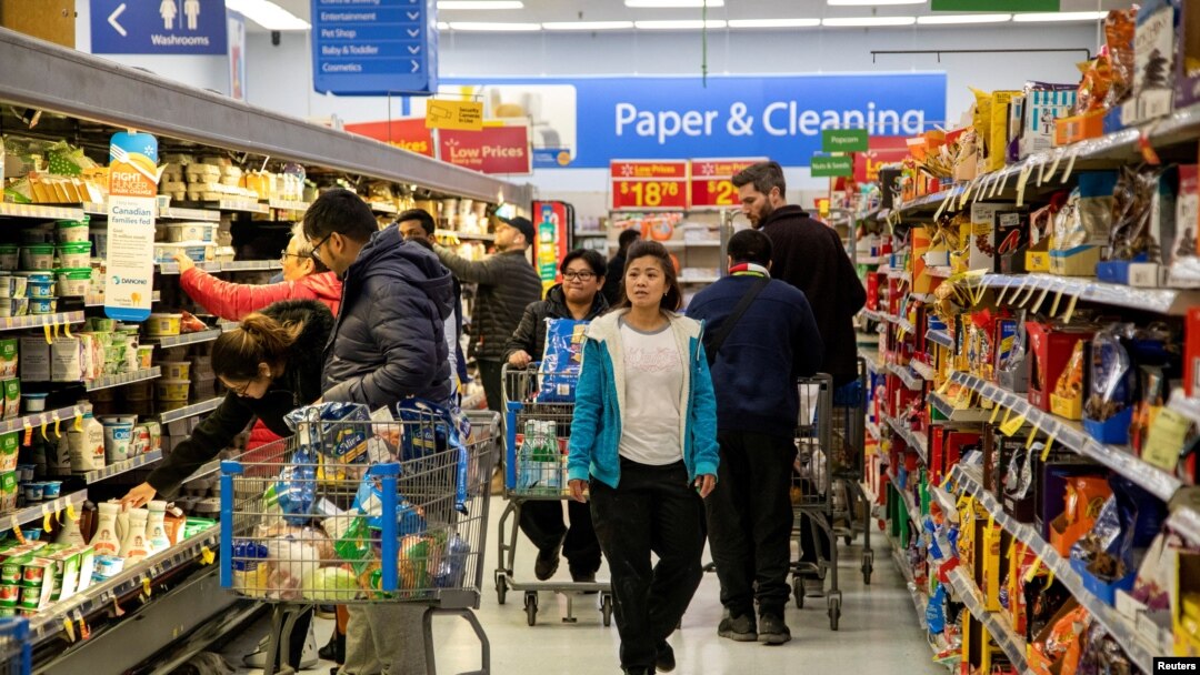 FILE - People shop at a Walmart Supercenter in Toronto, Ontario, Canada, March 13, 2020. Opposition parties in Canada say the government of Prime Minister Justin Trudeau is not doing enough to fight inflation.