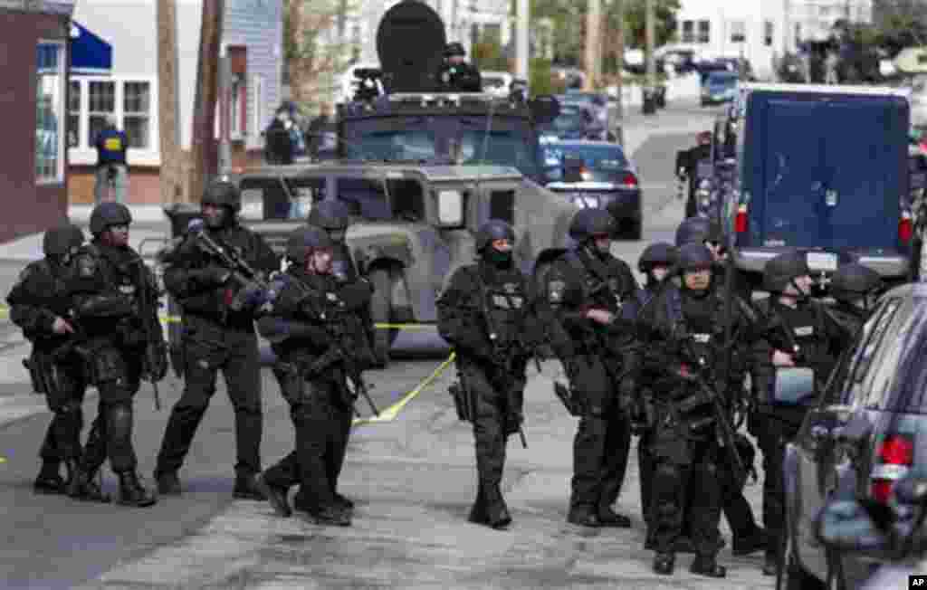 Heavily armed police continue to patrol the neighborhoods of Watertown, April 19, 2013.