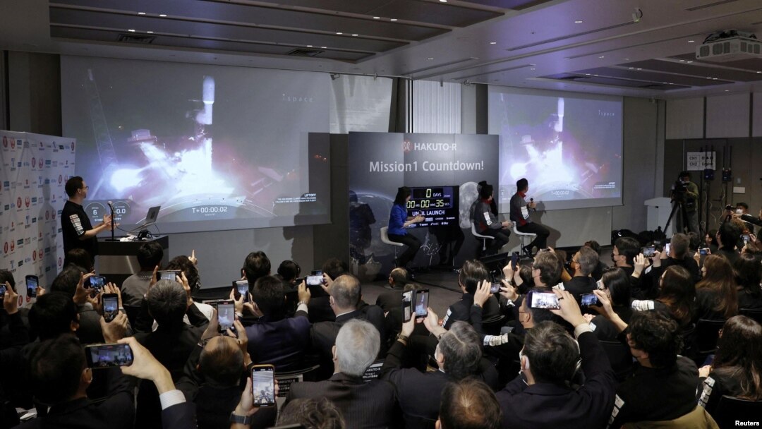Officials of ispace Inc's HAKUTO-R mission look at live broadcasting of the launch of a SpaceX Falcon 9 rocket for ispace at Cape Canaveral Space Force Station, in Tokyo, Dec. 11, 2022. (Kyodo via Reuters)