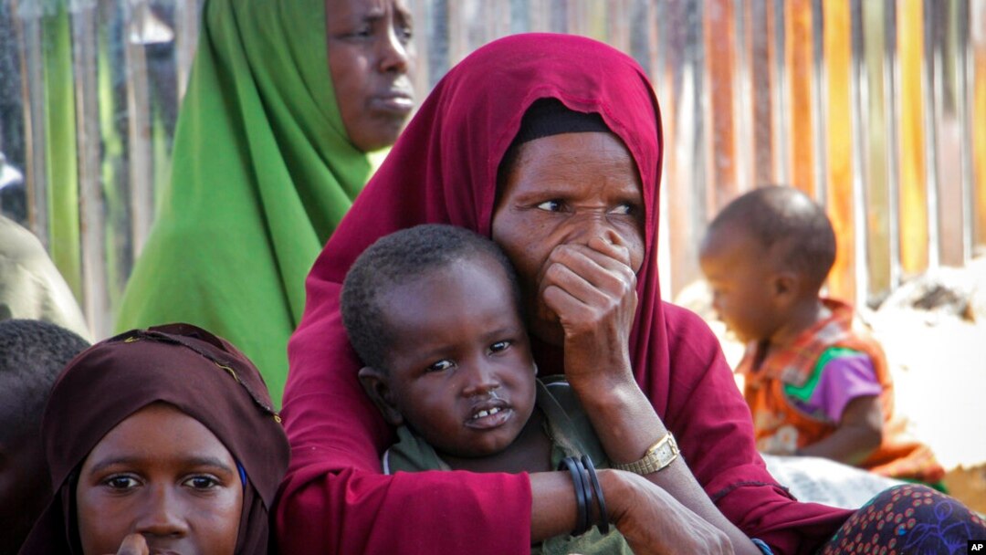 FILE - Somalis who fled drought-stricken areas of their country sit at a makeshift camp on the outskirts of the capital, Mogadishu, Feb. 4, 2022. Thousands of desperate families have fled a severe drought across large parts of Somalia.