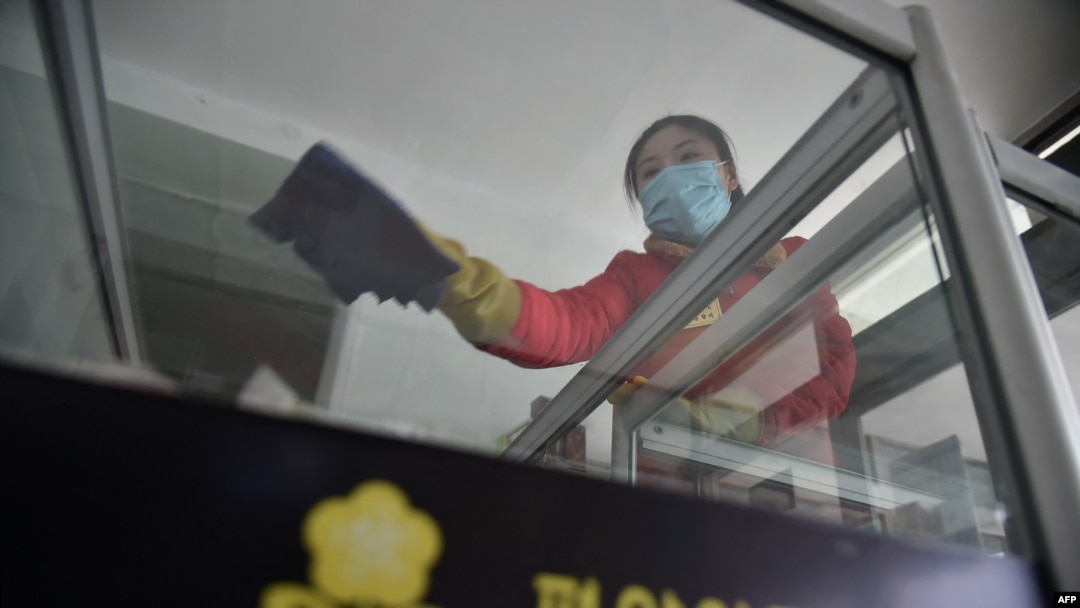 An employee cleans a surface as part of preventative measures against the COVID-19 coronavirus at the Pyongyang Children's Department Store in Pyongyang on March 18, 2022.