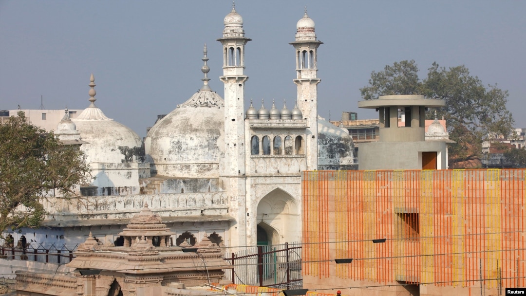 FILE - A worker stands on a temple rooftop adjacent to the Gyanvapi Mosque in the northern city of Varanasi, India, December 12, 2021. (REUTERS/Pawan Kumar/File Photo)