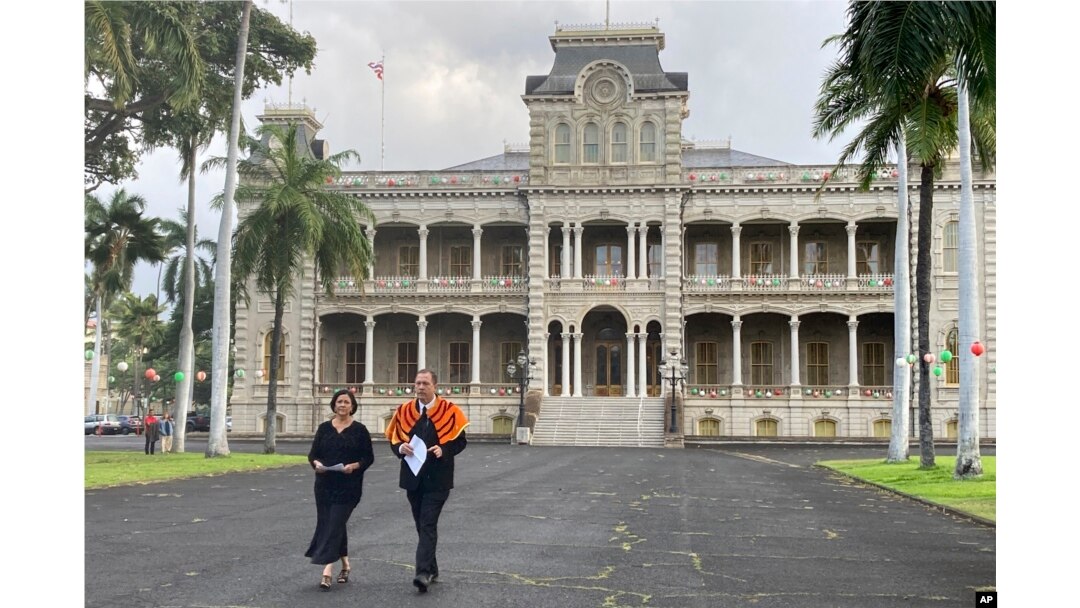Paula Akana, left, executive director of Iolani Palace, and Hailama Farden, of Hale O Na Aliʻi O Hawaii, a royal Hawaiian society, arrive at a news conference, Dec. 12, 2022, at the palace in Honolulu to announce the death of Abigail Kinoiki Kekaulike Kawānanakoa.