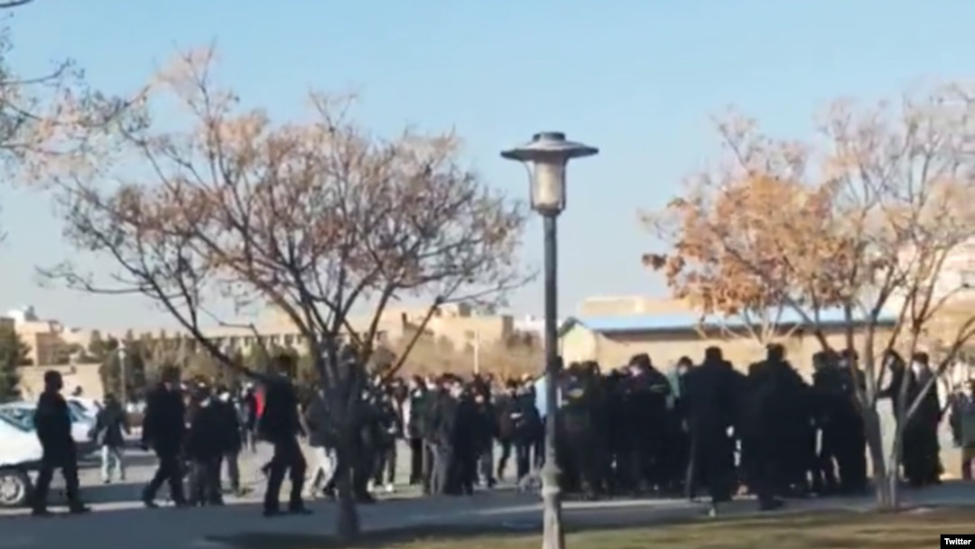 A screengrab from UGC video posted on Twitter Dec. 7, 2022, purports to show students clashing with security forces in Mashhad, Iran.