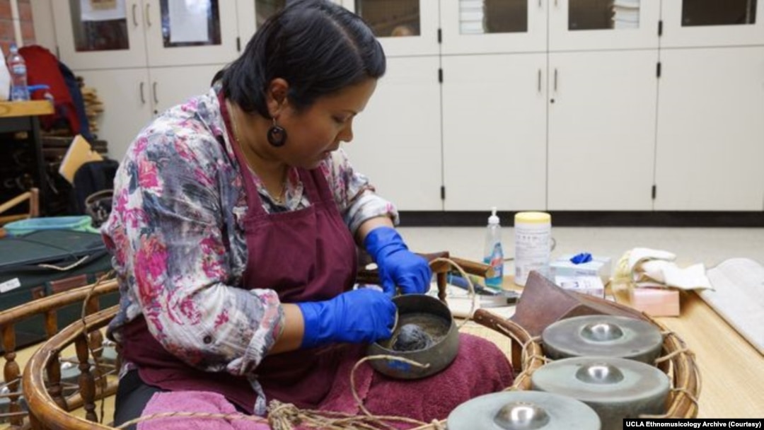 Supeena Insee Adler, a classical Thai musician, instrument repairer, and lecturer in ethnomusicology at UCLA, repairs a gong circle, known in Thai as a “Khong wong.”