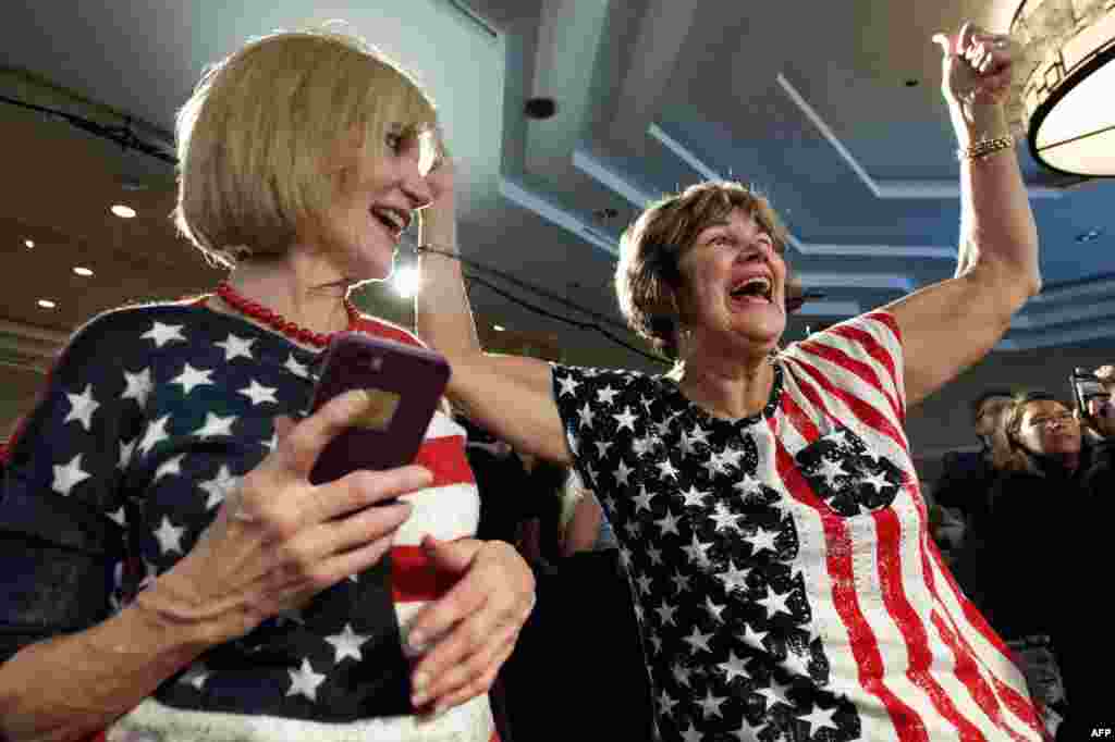 Karen Magnuson (L) and Kay Shaw celebrate after the announcement of the victory of Jason Crow, Democratic candidate for Colorado's 6th congressional District, during the Colorado Democrats watch party in Denver, Colorado, Nov. 6, 2018.