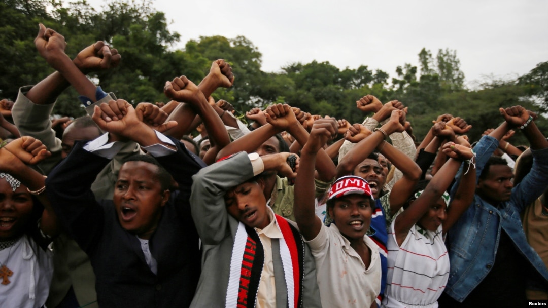 FILE - Demonstrators protest gesture during Irreecha, the thanksgiving festival of the Oromo people, in Bishoftu town, Oromia region, Ethiopia. More than 50 people were killed in the violence. 