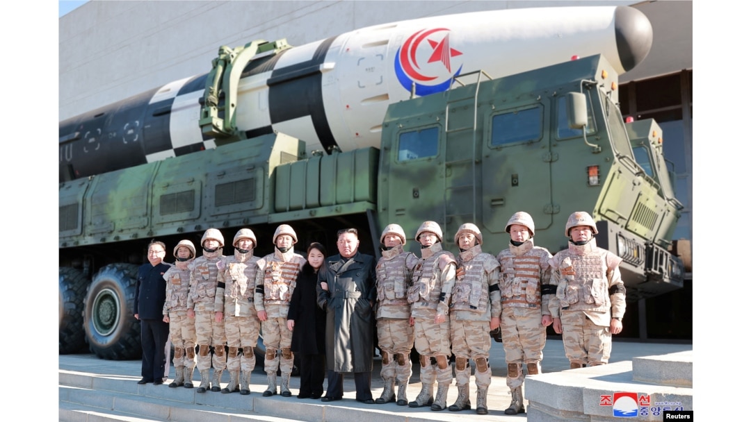 N. Korean leader Kim Jong Un and his daughter attend a photo session with the scientists, engineers and others involved in the test-fire of the new Hwasong-17 ICBM in this photo released Nov. 27, 2022 by N. Korea's KCNA via Reuters.